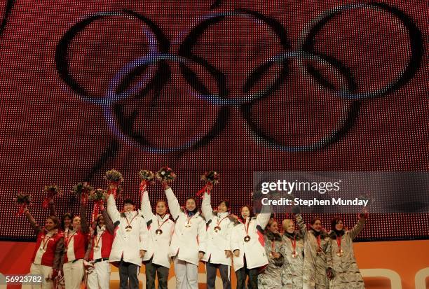 The Korean team of Chun-Sa Byun, Eun-Kyung Choi, Da-Hye Jeon, Sun-yu Jin, Yun-Mi Kang receive the Gold medal with The Canadian team of Alanna Kraus,...