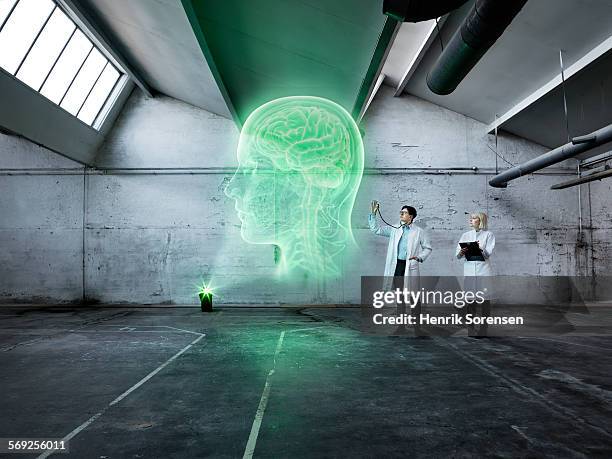 scientists examining a holographic human head - male likeness stock pictures, royalty-free photos & images