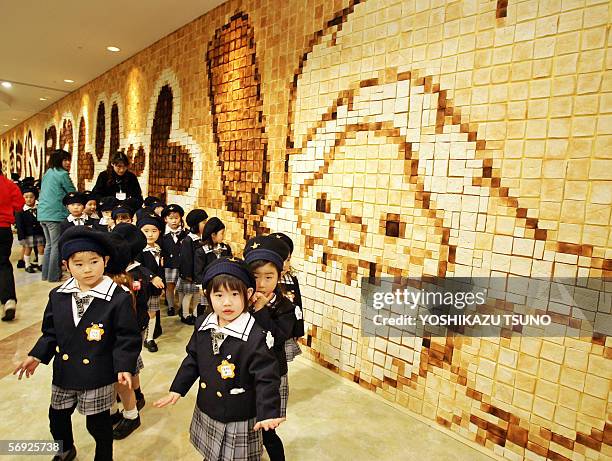 Kindergarten children admire as they put the final touches on an art work made of toasted bread at a bread theme park in Funabashi, suburban Tokyo,...
