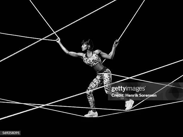 female athlete balancing on ropes - white rope stock pictures, royalty-free photos & images