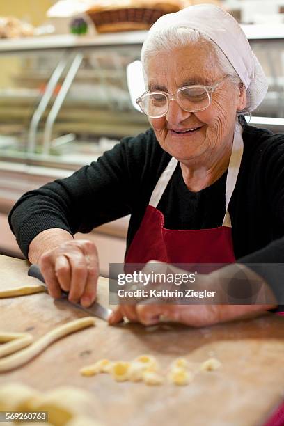 elderly woman making fresh pasta - puglia stock pictures, royalty-free photos & images
