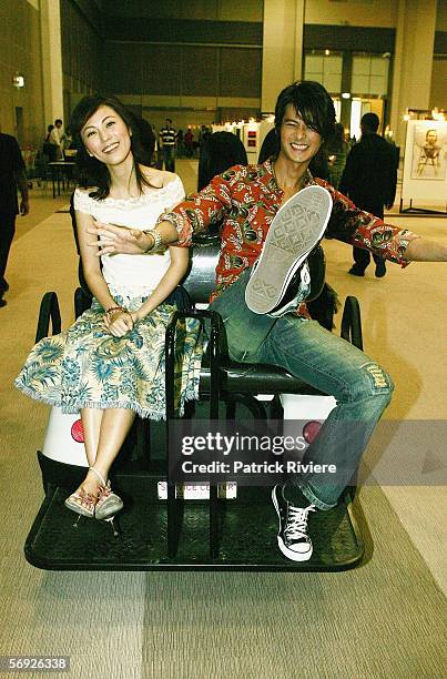 Actors Annie Liu and Dylan Kuo Pin Chao get a buggy ride to a press conference during the Bangkok International Film Festival at Siam Paragon...