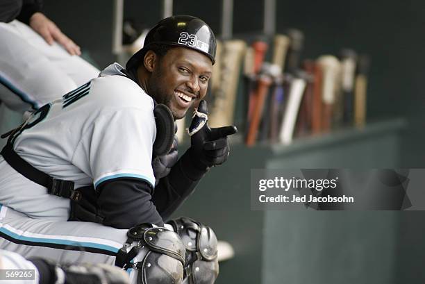 Catcher Charles Johnson of the Florida Marlins smiles in the dugout with his equipment on during the MLB game against the San Francisco Giants at...