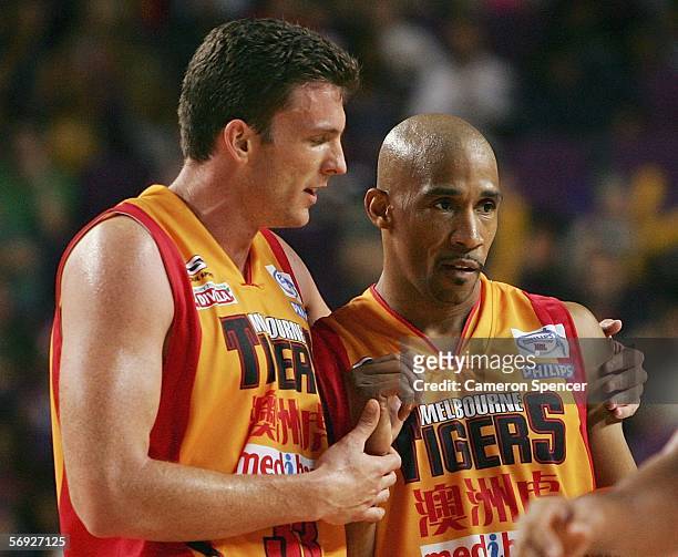 Stephen Hoare of the Tigers congratulates team mate Darryl McDonald after winning game one of the NBL Grand Final between the Sydney Kings and the...