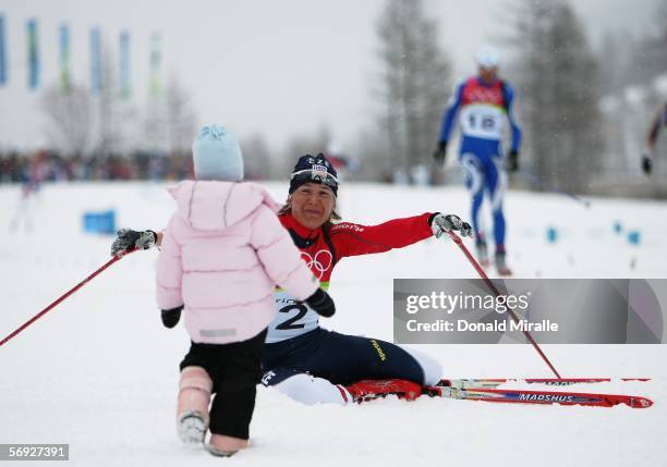 Gold medal winner Katerina Neumannova of the Czech Republic celebrates with her daughter Lucie in the Womens Cross Country Skiing 30km Mass Start...