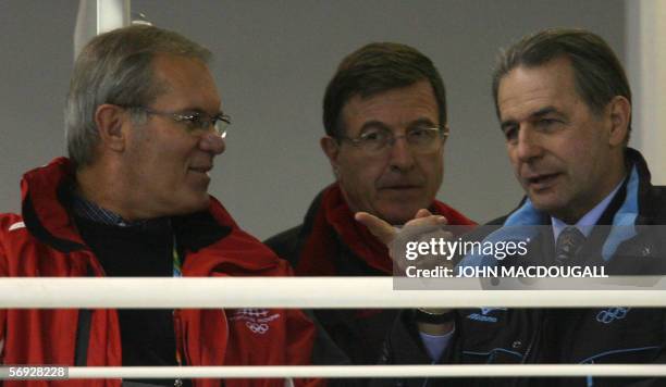 President of the International Olympic Committee Jacques Rogge speaks to vice-president of the World Curling Federation Les Harrison as they watch...