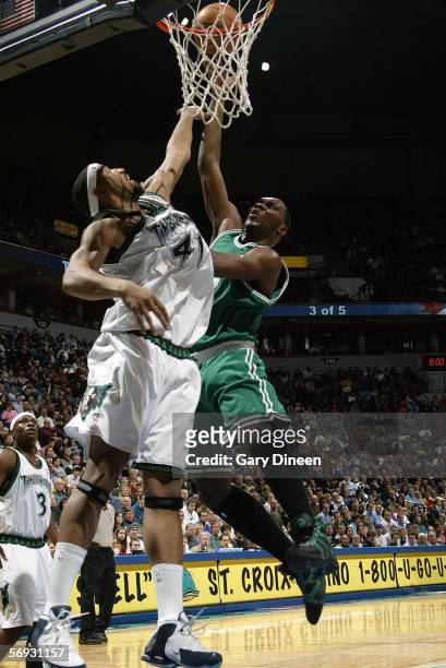 Al Jefferson of the Boston Celtics takes the ball to the basket against Eddie Griffin of the Minnesota Timberwolves during a game at Target Center on...