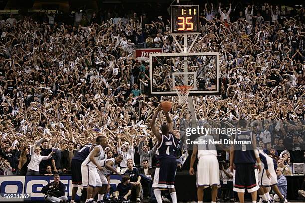 The student section of the Villanova Wildcats attempts to distract Jeff Adrien of the Connecticut Huskies while shooting a free throw on February 13,...