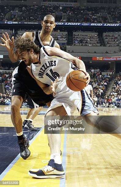 Pau Gasol of the Memphis Grizzlies drives past Tim Duncan of the San Antonio Spurs on February 24, 2006 at FedExForum in Memphis, Tennessee. The...