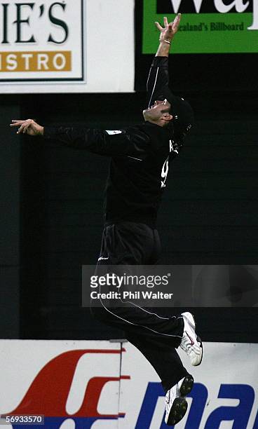 Nathan Astle of New Zealand leaps up outside of the boundary rope to make a stunning catch to dismiss Dwayne Smith of the West Indies during the...