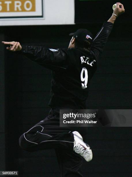 Nathan Astle of New Zealand leaps up outside of the boundary rope to make a stunning catch to dismiss Dwayne Smith of the West Indies during the...