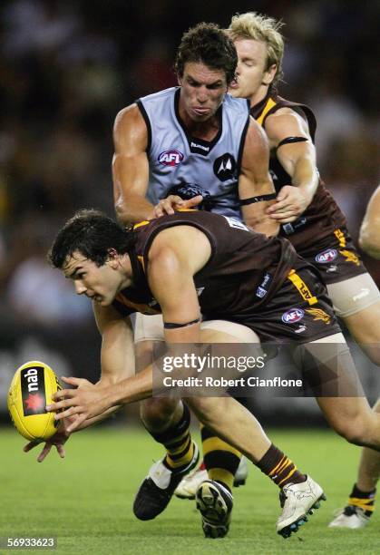 Jordan Lewis for the Hawks is tackled by Troy Simmonds for the Tigers during the round one NAB Cup match between the Hawthorn Hawks and the Richmond...
