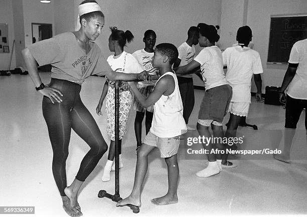 At Alvin Ailey Camp, dance instructor Adrienne Armstrong speaks to young male and female students, June 6, 1979.