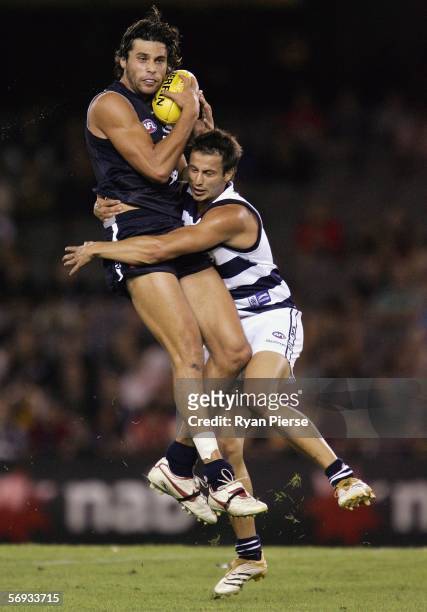 Setanta O'hAilpin for the Blues is tacked by Paul Koulouriotis for the Cats during the round one NAB Cup match between the Carlton Blues and the...