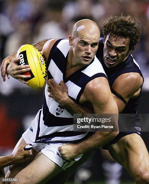 Cory McGrath for the Blues tackles Paul Chapman for the Cats during the round one NAB Cup match between the Carlton Blues and the Geelong Cats at the...