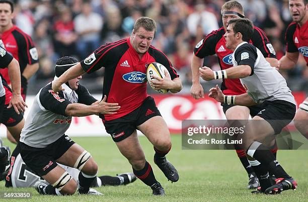 Campbell Johnstone of the Crusaders runs through the tackle of Jacques Botes of the Sharks during the round 3 Super 14 match between the Crusaders...