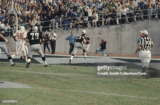 Fred Biletnikoff and football team during a National Football League game between the Oakland Raiders and the New England Patriots, 1975.