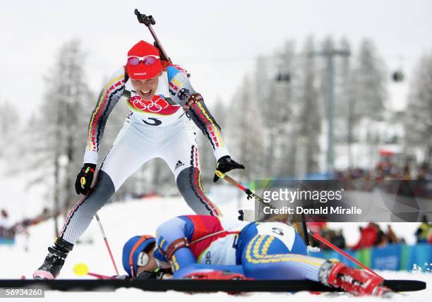 Kati Wilhelm of Germany smiles as she approaches Anna Carin Olofsson of Sweden at the finsh line in the Womens Biathlon 12.5km Mass Start Final on...
