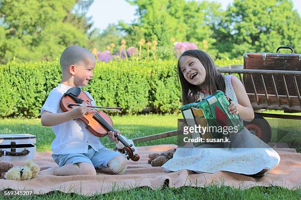 girl & brother playing musical instruments outdoor - harmonica stock pictures, royalty-free photos & images