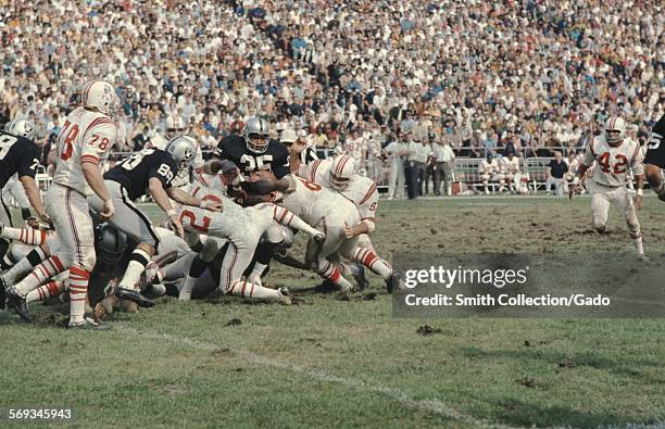 Hewritt Dixon, Drew Buie, and football team during a National Football League game between the Oakland Raiders and the New England Patriots, 1975.