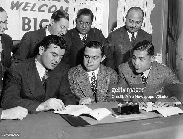 Joe Louis and his managers sealing the works for the heavyweight championship bought in June in Chicago with white titleholder Jim Braddock, 1937.