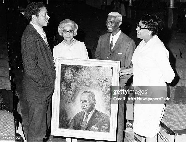 Margaret Armstrong, Eddie Watson, Pearl Brackett, and others holding a portrait of Martin Luther King Jr, 1975.