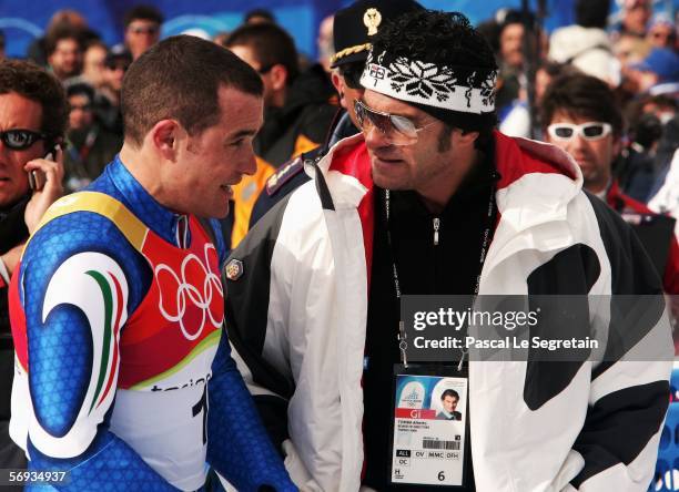 Giorgio Rocca of Italy talks to Alberto Tomba in the Final of the Mens Alpine Skiing Slalom on Day 15 of the 2006 Turin Winter Olympic Games on...
