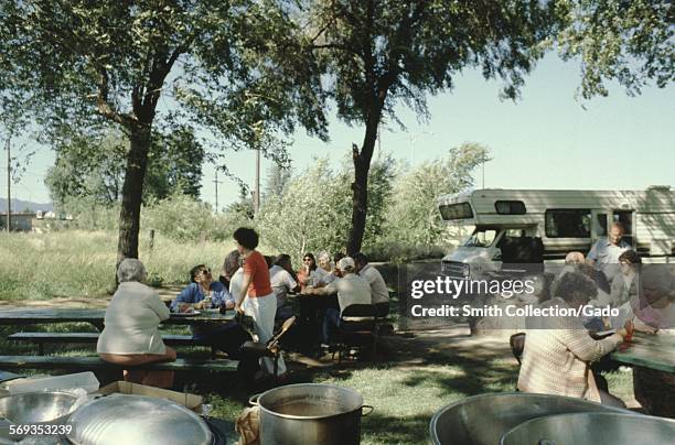 Vernacular snapshot photograph of picnic tables and camper, 1966.