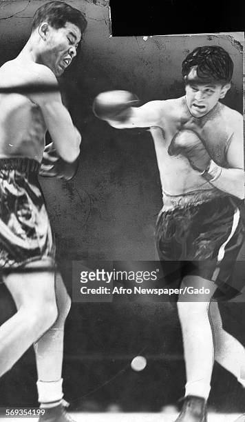 World Heavyweight Joe Louis taking a hit from Billy Conn, 1941.