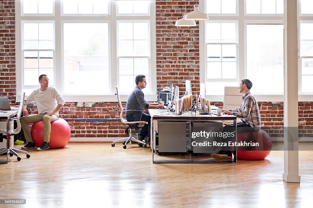 Coworkers in casual communication in office