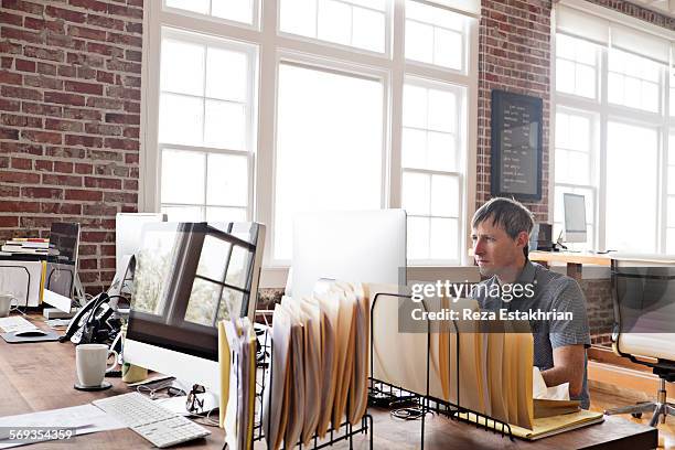 man works in open plan office - computer desktop folder stock pictures, royalty-free photos & images