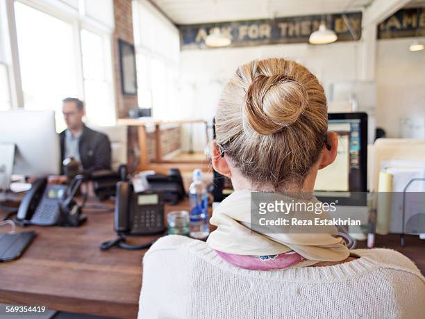 rear view of women at computer - hair bun scarf woman stock pictures, royalty-free photos & images