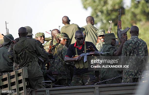 Ugandan soldier loads his AK47 assault rifle gun 25 February 2006 after the truck he was riding in was stoned by opposition supporters in Kampala....