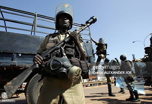 Ugandan police arrive to search for rock-throwers 25 February 2006 after dispersing with live rounds and teargas supporters of opposition leader...