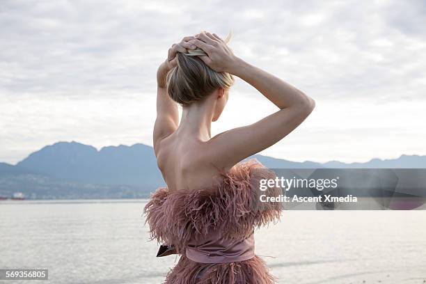 female model looks out across bay to city, hills - high fashion model stock pictures, royalty-free photos & images