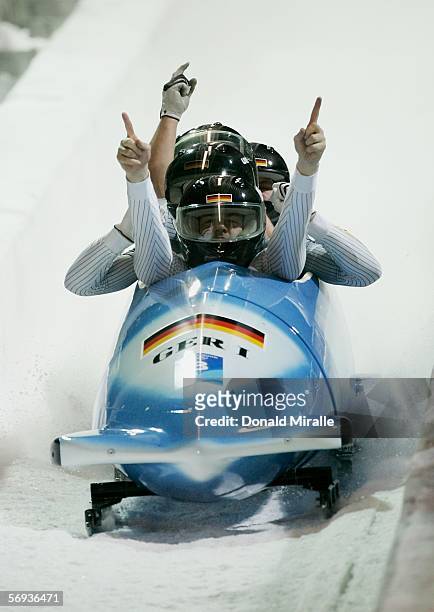 Pilot Andre Lange and teammates Rene Hoppe, Kevin Kuske and Martin Putze of Germany 1 celebrate their gold medal run in the Four Man Bobsleigh Final...