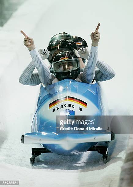 Pilot Andre Lange and teammates Rene Hoppe, Kevin Kuske and Martin Putze of Germany 1 celebrate their gold medal run in the Four Man Bobsleigh Final...
