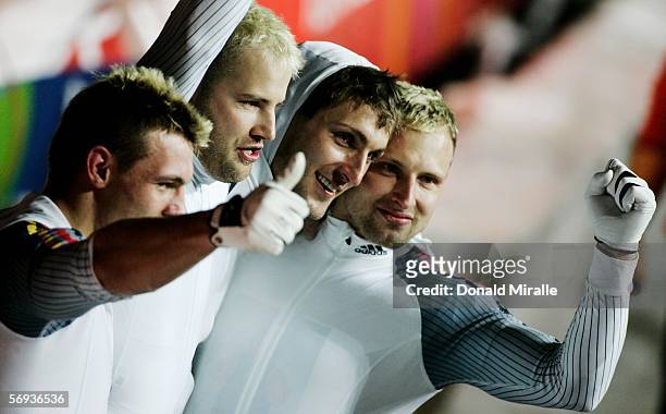 Pilot Andre Lange and teammates Rene Hoppe, Kevin Kuske and Martin Putze of Germany 1 celebrate their gold medal in the Four Man Bobsleigh Final on...