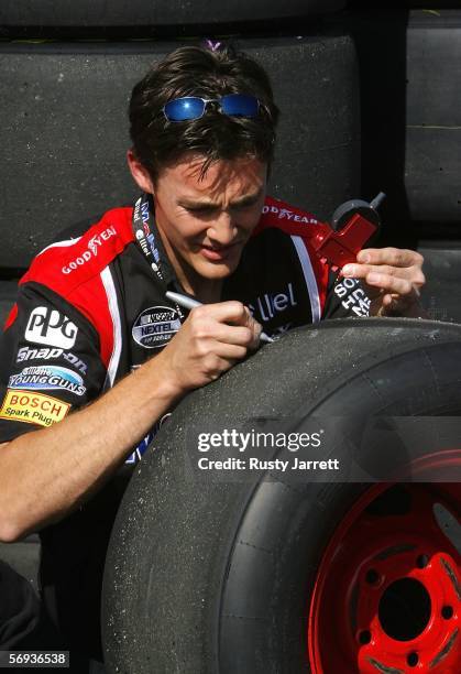 Crew member of the Alltel Dodge driven by Ryan Newman measures tire wear, during practice for the NASCAR Nextel Cup Series Auto Club 500 on February...