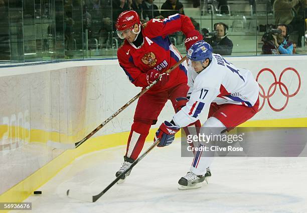 Alexei Yashin of Russia and Filip Kuba of Czech Republic fight for the puck during the bronze medal match of the men's ice hockey match between...
