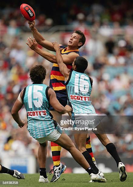Ivan Maric of the Crows gets a handball away despite pressure from his power opponents during the round one NAB Cup match between the Adelaide Crows...