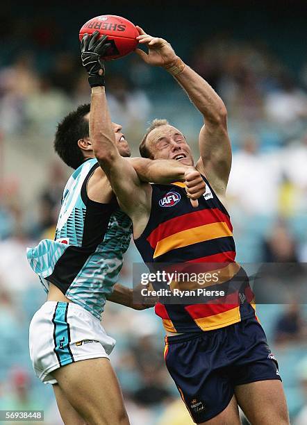 Ian Perrie of the Crows contests the ball against Troy Chaplin of the Power during the round one NAB Cup match between the Adelaide Crows and the...