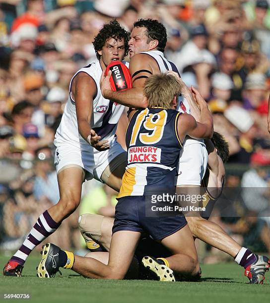 Antoni Grover of the Dockers tries to break clear from Mark LeCras of the Eagles during the round one NAB Cup match between the West Coast Eagles and...