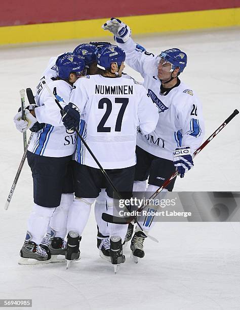 Team Finland celebrates Kimmo Timonen's first period goal to take a 1-0 lead over Sweden in the final of the men's ice hockey match between Finland...