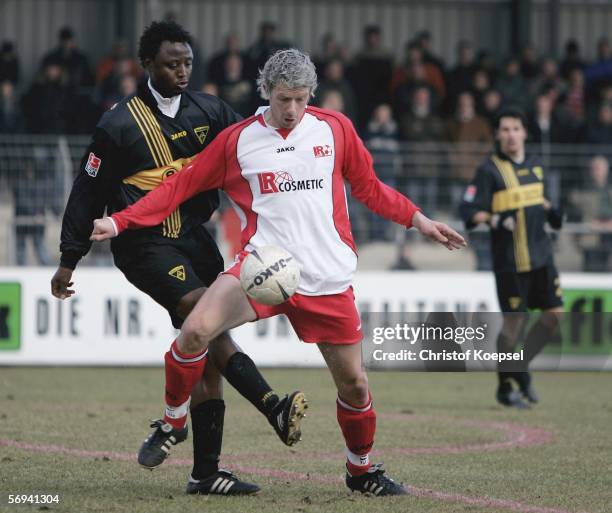 Moses Sichone of Aachen tackles Nico Patschinski of Ahlen during the match of the Second Bundesliga between LR Ahlen and Alemannia Aachen at the...