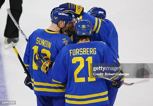 Nicklas Lidstrom of Sweden is congratulated by teammates after scoring a third period goal to take a 3-2 lead over Finland during the final of the...