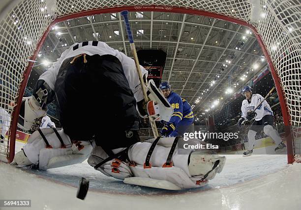 The puck gets past goalie Antero Niittymaki of Finland for a goal by Henrik Zetterberg of Sweden to tie the score 1-1 during the final of the men's...