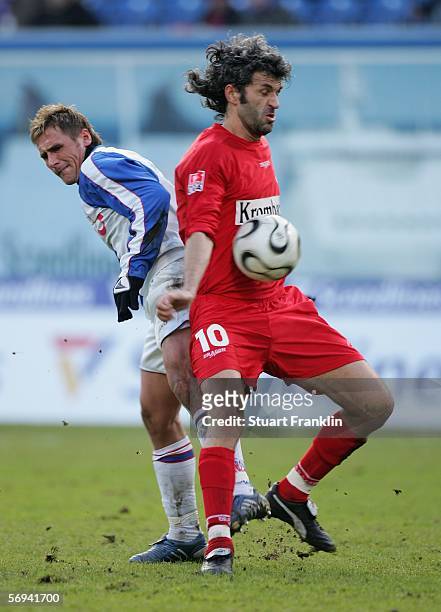 Marcel Schied of Rostock challenges Peter Nemeth of Siegen during the Second Bundesliga match between FC Hansa Rostock and Sportfreunde Siegen at the...