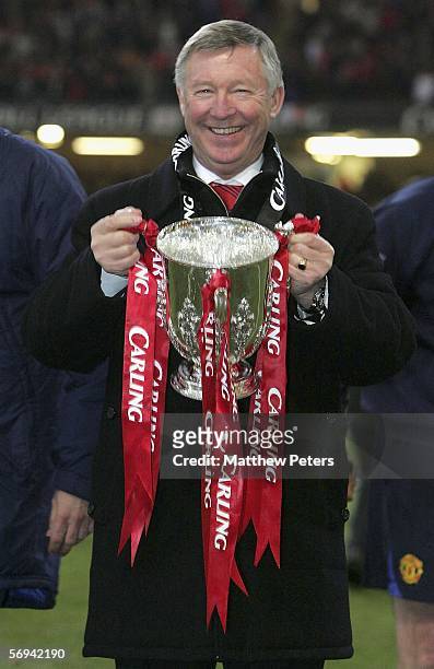 Sir Alex Ferguson of Manchester United poses with the Carling Cup trophy after the Carling Cup Final match between Manchester United and Wigan...