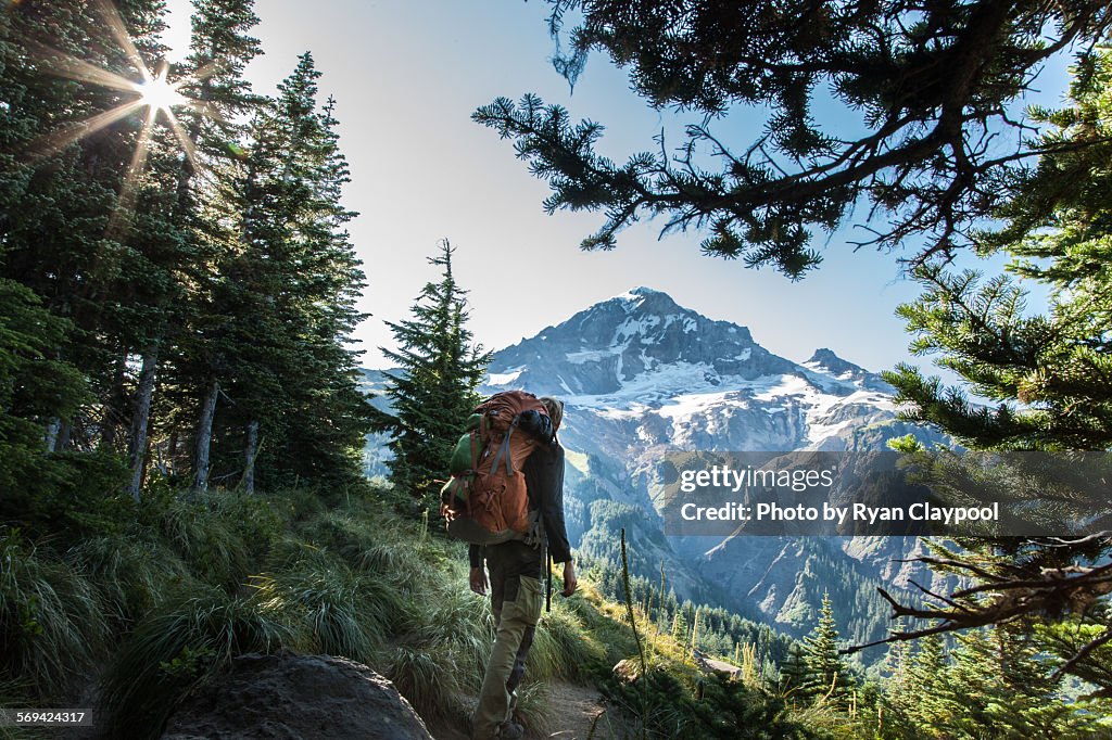 A hiker in front of Mt. Hood in the early morning